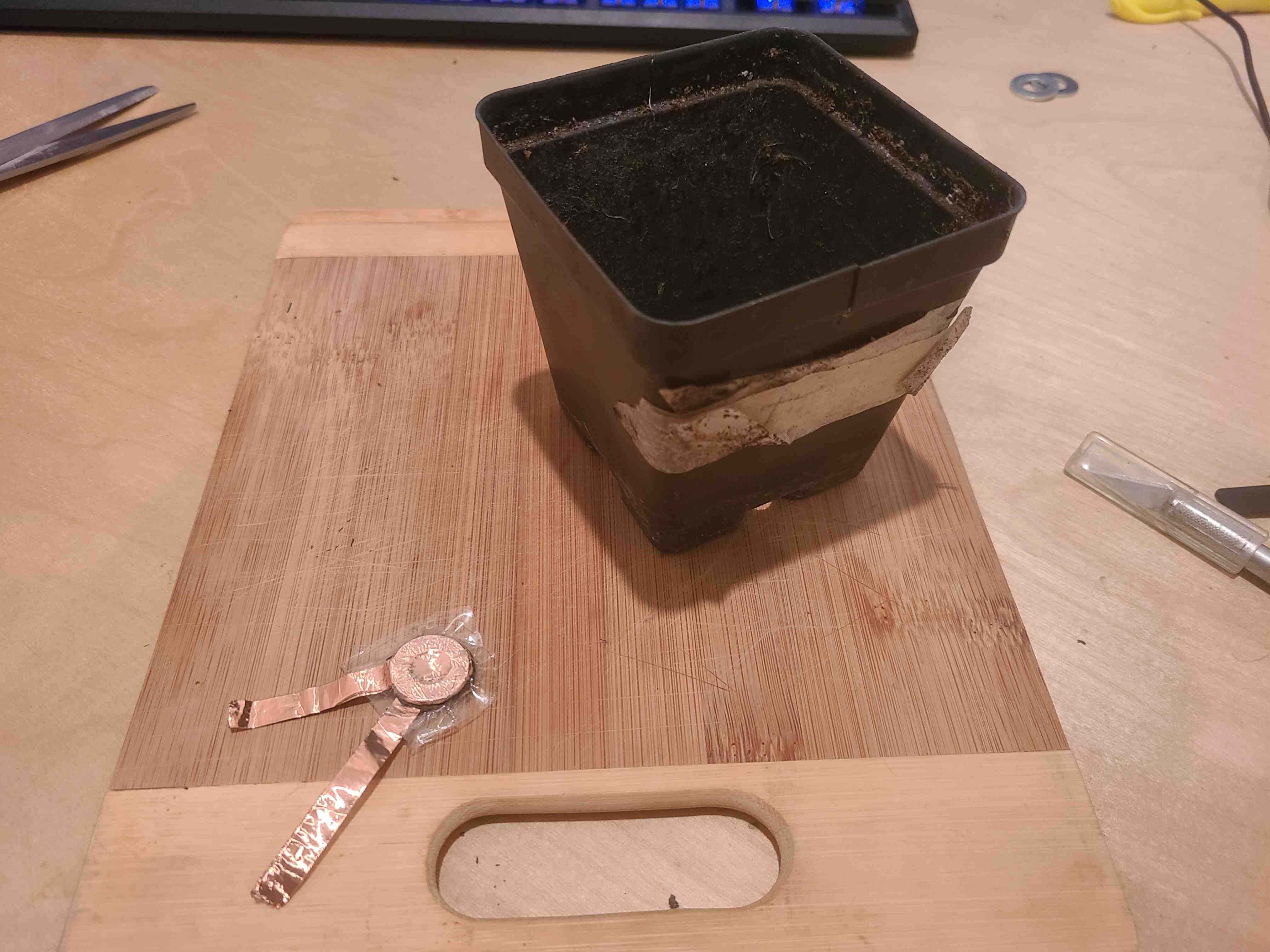 A sandwich of packing tape, copper coated washer, velostat, copper coated washer, packing tape.